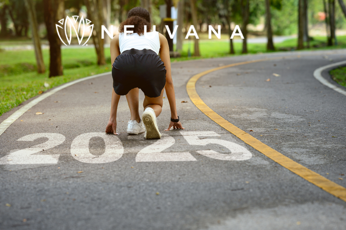Woman in a sprinters position and 2025 is written on the road