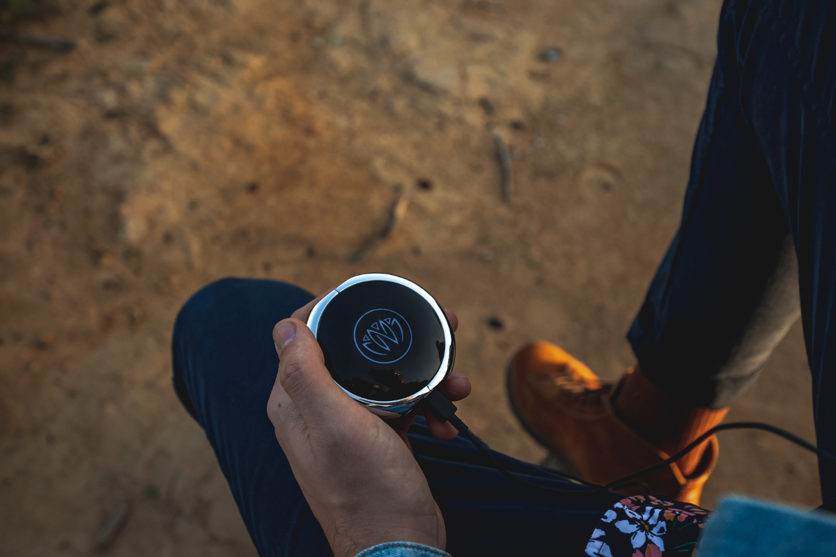 A guy holding the neuvana device in his hands