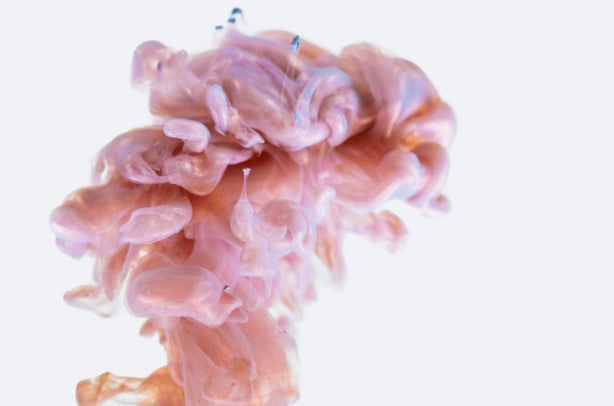 Pink and blue liquid flows in an upward motion simulating cranial fluid