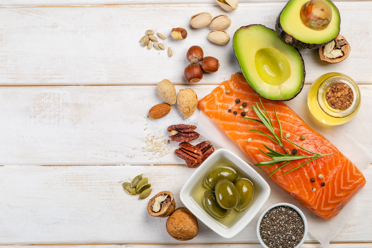 colorful foods like salmon, nuts, avocado, herbs, and olives