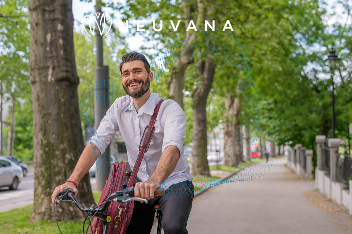 A man riding a bike smiling 