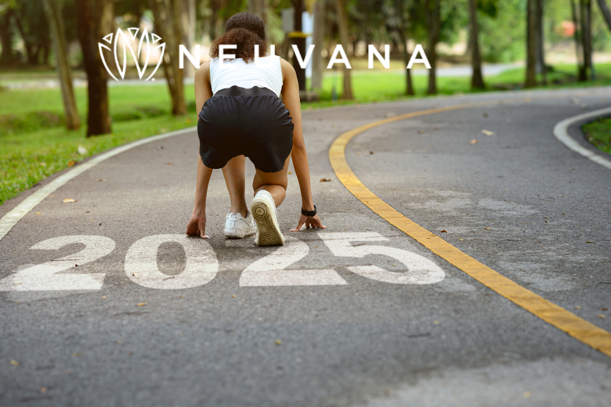 Woman in a sprinters position and 2025 is written on the road 