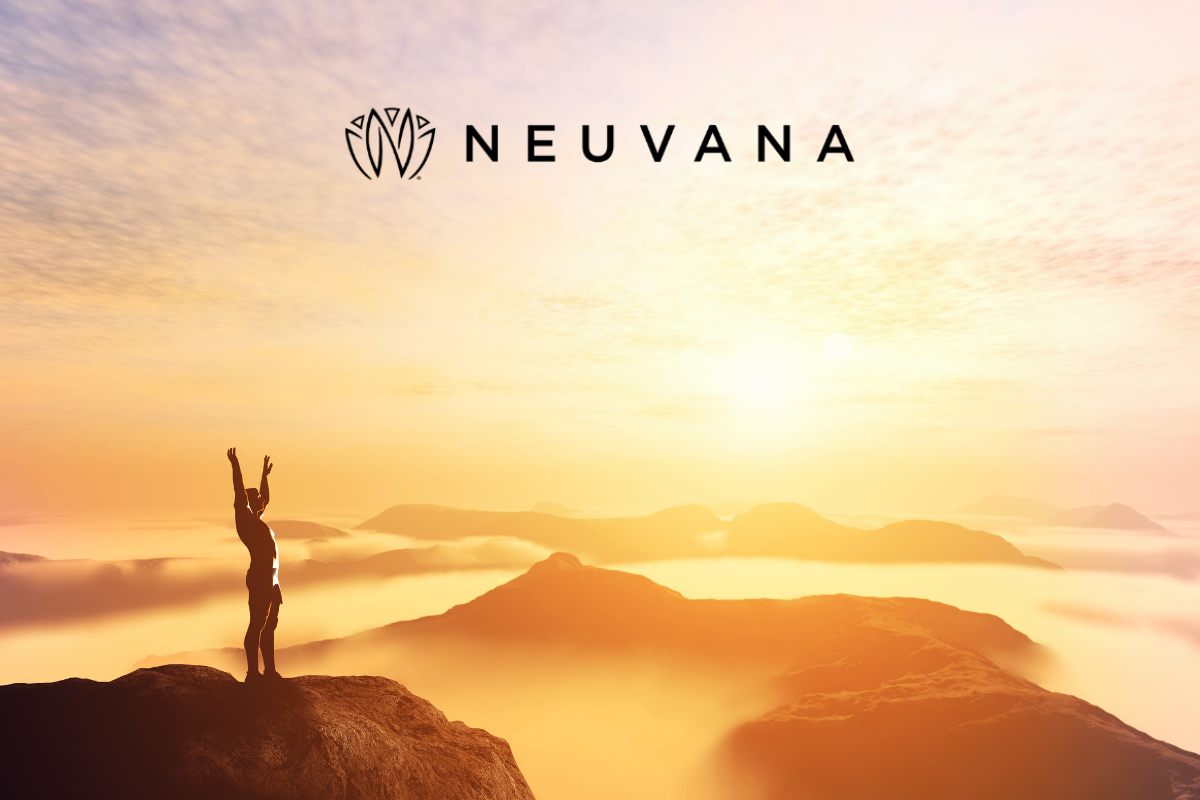 A person standing on a mountain peak with arms raised, looking at a breathtaking sunrise over a misty, mountainous landscape, with the Neuvana logo at the top
