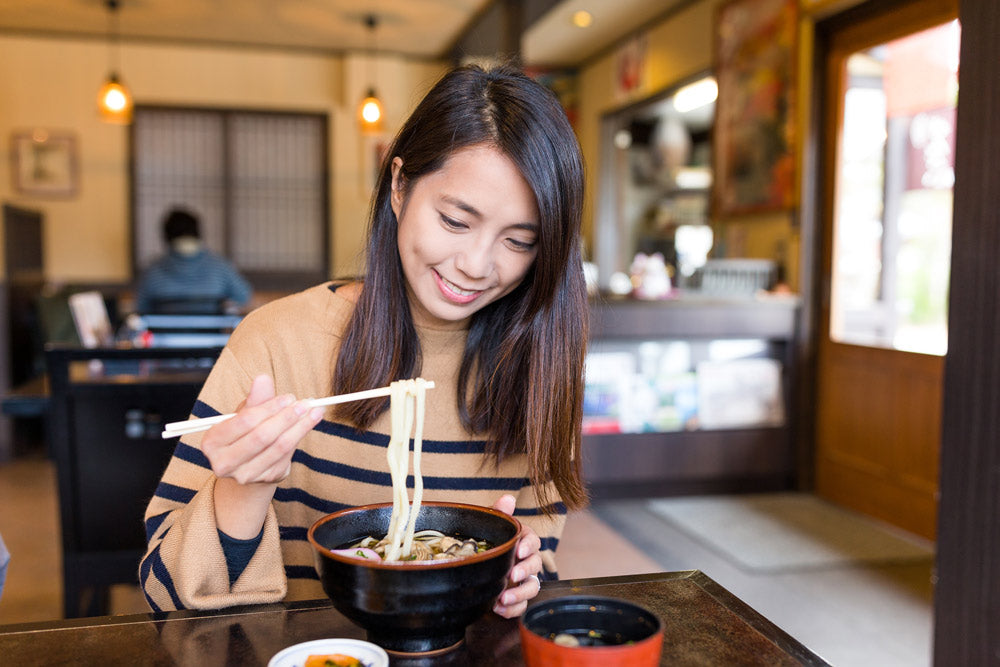 girl eating ramen noodles